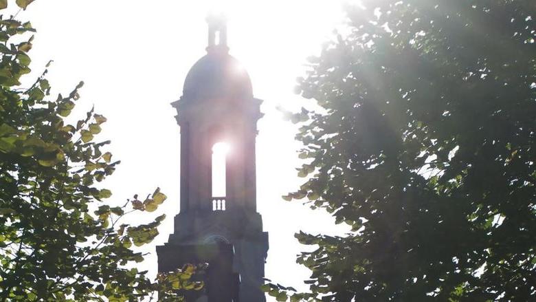 Sun streaming through Penn State's Old Main bell tower